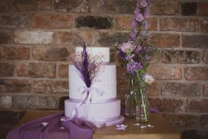 three tier wedding cake with floral arrangement